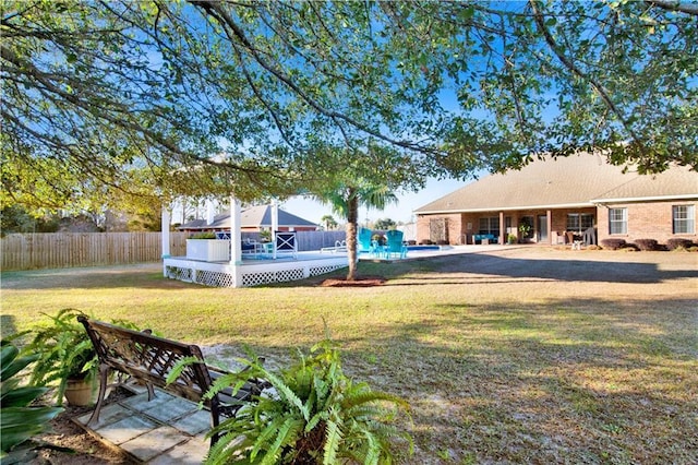 view of yard with a swimming pool side deck