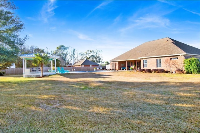 view of yard featuring a fenced in pool and a pergola