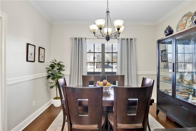 dining room featuring a chandelier, dark hardwood / wood-style floors, and ornamental molding