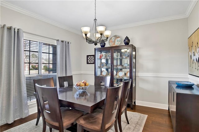 dining area featuring ornamental molding, dark hardwood / wood-style floors, and an inviting chandelier