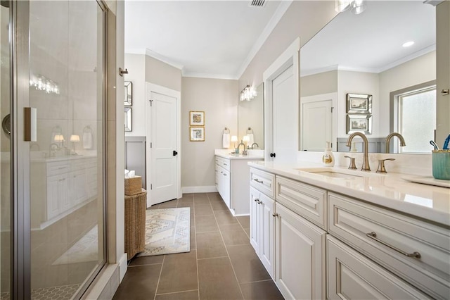 bathroom with tile patterned flooring, vanity, ornamental molding, and walk in shower