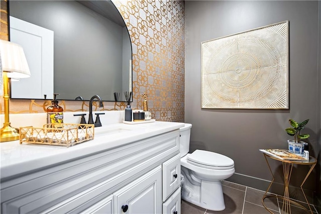 bathroom featuring toilet, vanity, and tile patterned floors