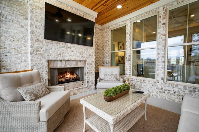 interior space featuring an outdoor brick fireplace and wooden ceiling