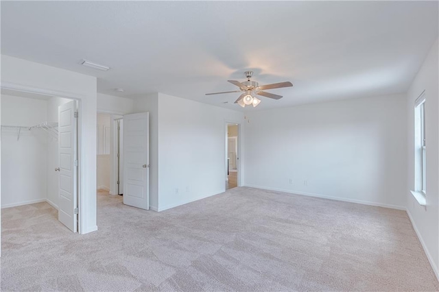 3473 Summer Woods Cir W, Mobile, AL 36695 - unfurnished bedroom with light colored carpet, a walk in closet, a closet, and a ceiling fan