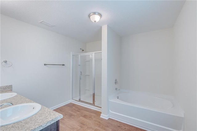 3473 Summer Woods Cir W, Mobile, AL 36695 - bathroom with a garden tub, a stall shower, wood finished floors, double vanity, and baseboards