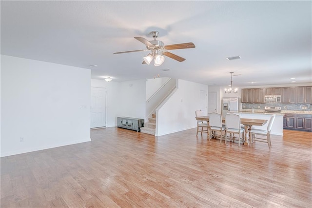 3473 Summer Woods Cir W, Mobile, AL 36695 - living area with stairway, a chandelier, light wood finished floors, ceiling fan, and baseboards