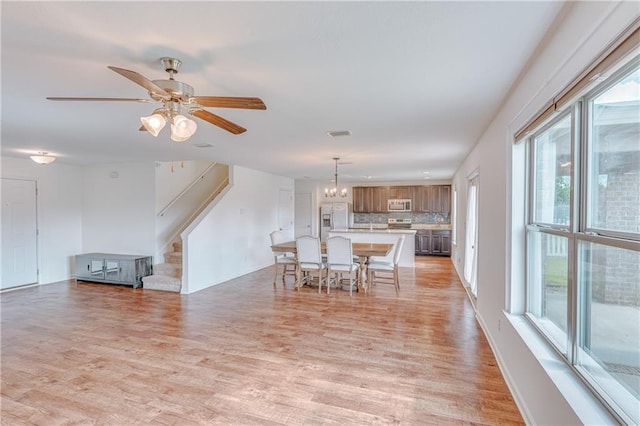 3473 Summer Woods Cir W, Mobile, AL 36695 - dining room featuring stairs, light wood finished floors, ceiling fan, and a chandelier