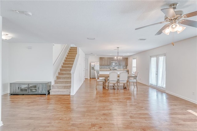 3473 Summer Woods Cir W, Mobile, AL 36695 - dining room featuring stairway, light wood-type flooring, baseboards, ceiling fan, and a textured ceiling