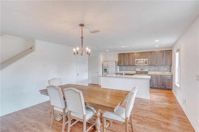3473 Summer Woods Cir W, Mobile, AL 36695 - dining room featuring a chandelier, light wood-style floors, recessed lighting, and baseboards