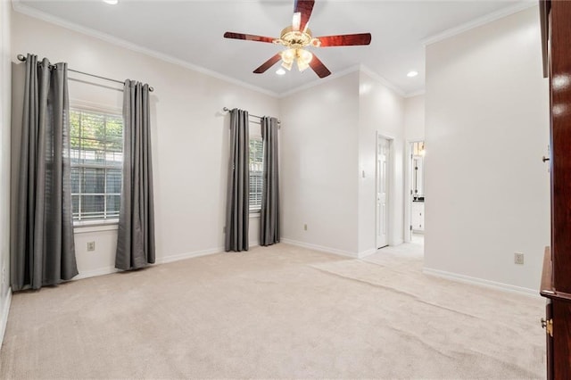 spare room featuring ornamental molding, a ceiling fan, recessed lighting, baseboards, and light colored carpet