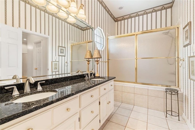 bathroom with a sink, tile patterned floors, and wallpapered walls