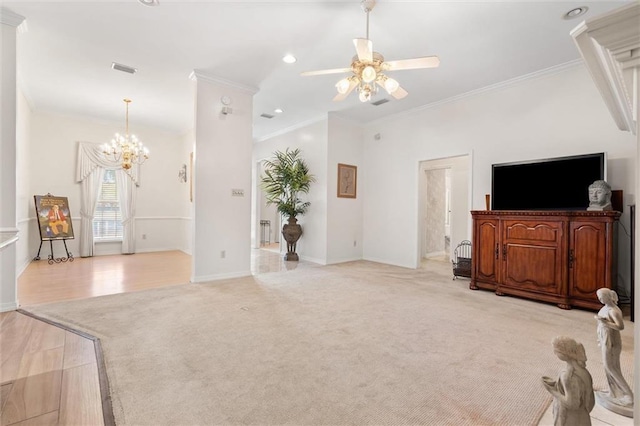 living room featuring visible vents, light carpet, ceiling fan with notable chandelier, crown molding, and baseboards