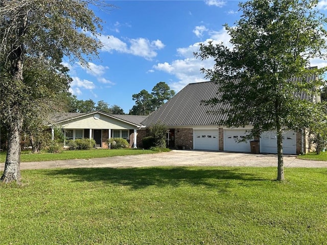view of front facade featuring a front yard, brick siding, driveway, and metal roof