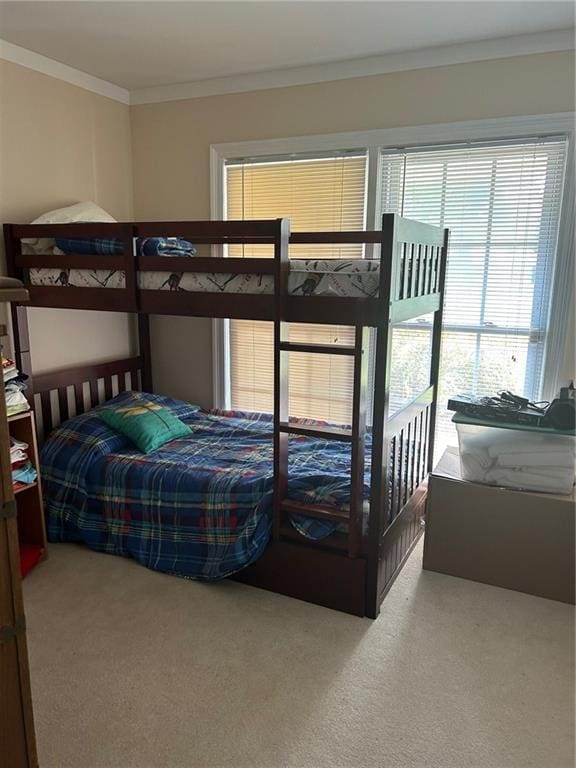 carpeted bedroom featuring crown molding