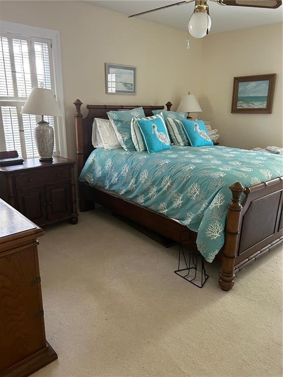 bedroom with ceiling fan and light colored carpet