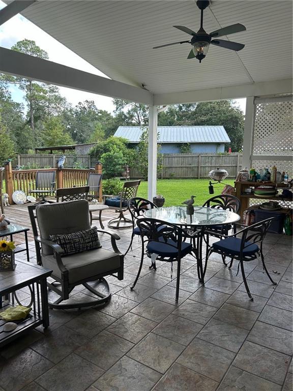 view of patio / terrace with a fenced backyard, outdoor dining space, and ceiling fan