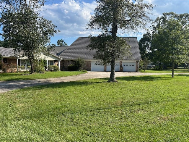 view of side of home with a yard, metal roof, and a garage
