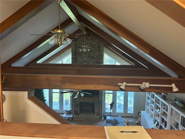 unfurnished living room featuring a brick fireplace, a wealth of natural light, and ceiling fan