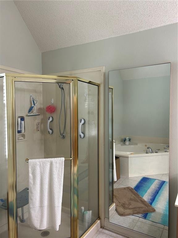 bathroom with a textured ceiling, shower with separate bathtub, and vaulted ceiling