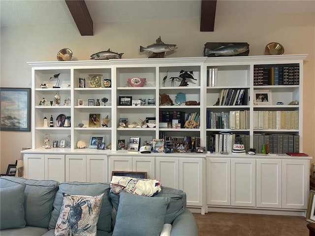 living area featuring beam ceiling and carpet floors