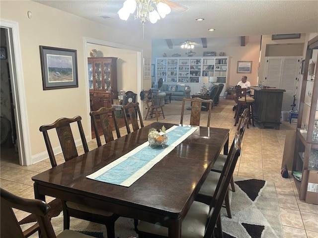 dining area featuring visible vents, a textured ceiling, a ceiling fan, and light tile patterned flooring
