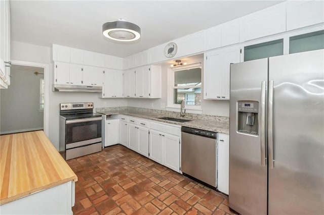 kitchen featuring a sink, white cabinetry, under cabinet range hood, and stainless steel appliances