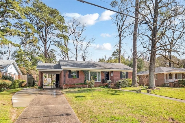 ranch-style house featuring brick siding, a front lawn, fence, concrete driveway, and a carport