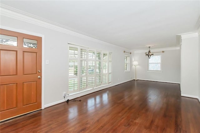 entrance foyer with an inviting chandelier, crown molding, baseboards, and wood finished floors