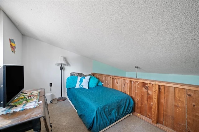 carpeted bedroom with a textured ceiling, lofted ceiling, and wooden walls