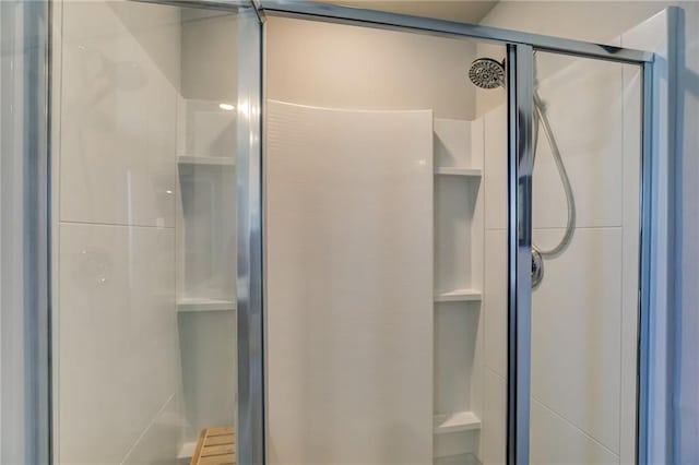 bathroom featuring a shower with door