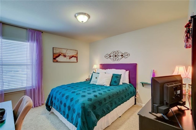 carpeted bedroom featuring multiple windows