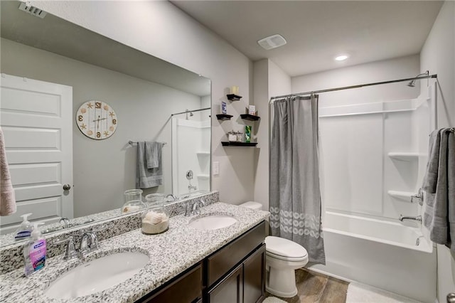 full bathroom with double sink vanity, wood-type flooring, toilet, and shower / tub combo with curtain