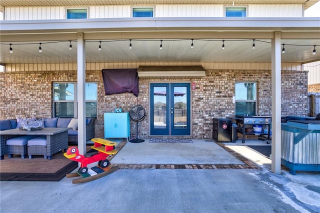 doorway to property with french doors, outdoor lounge area, and a patio