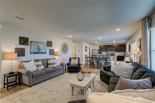 living room with light hardwood / wood-style flooring