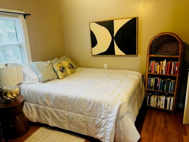 bedroom with dark hardwood / wood-style flooring