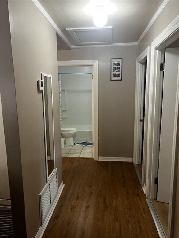 hall with ornamental molding and dark wood-type flooring