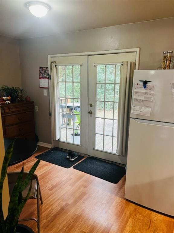 entryway featuring french doors and light wood-type flooring