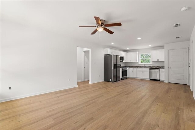 kitchen featuring ceiling fan, white cabinetry, visible vents, appliances with stainless steel finishes, and light wood finished floors