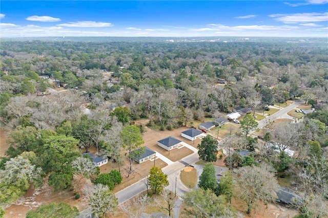 bird's eye view with a wooded view