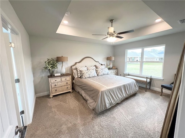 bedroom with ceiling fan, baseboards, carpet flooring, recessed lighting, and a raised ceiling