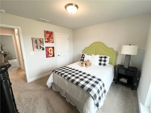 bedroom with visible vents, light carpet, and baseboards