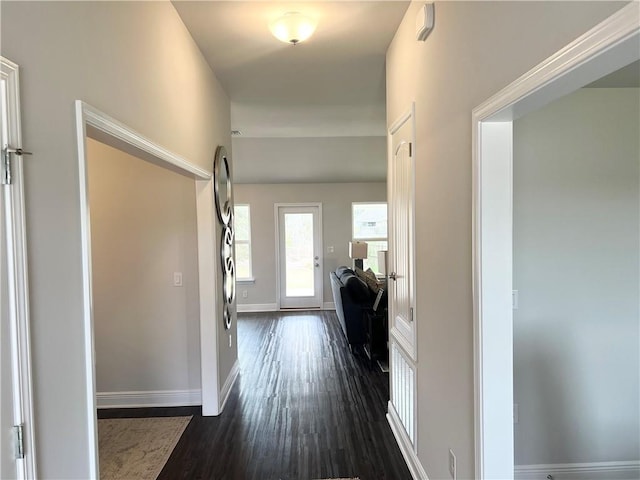 hall featuring dark wood-style floors and baseboards