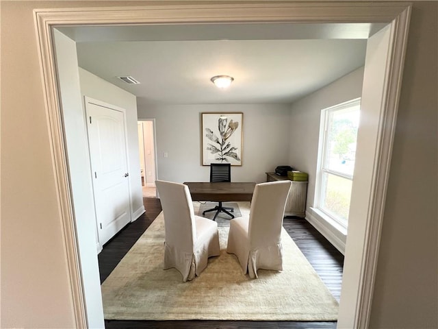 office featuring baseboards, visible vents, and dark wood-style flooring