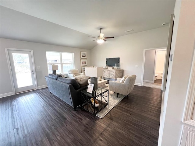 living room featuring baseboards, dark wood-type flooring, ceiling fan, and vaulted ceiling