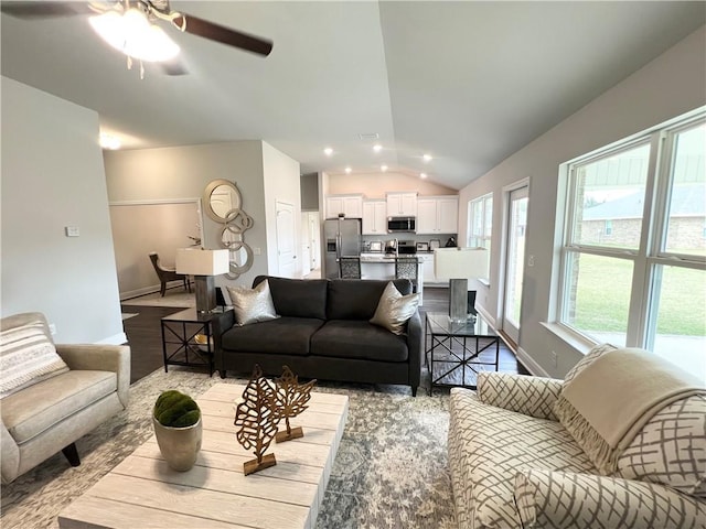 living area with recessed lighting, baseboards, wood finished floors, and vaulted ceiling