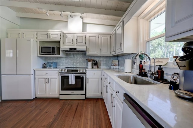 kitchen featuring vaulted ceiling with beams, white cabinets, sink, backsplash, and stainless steel appliances