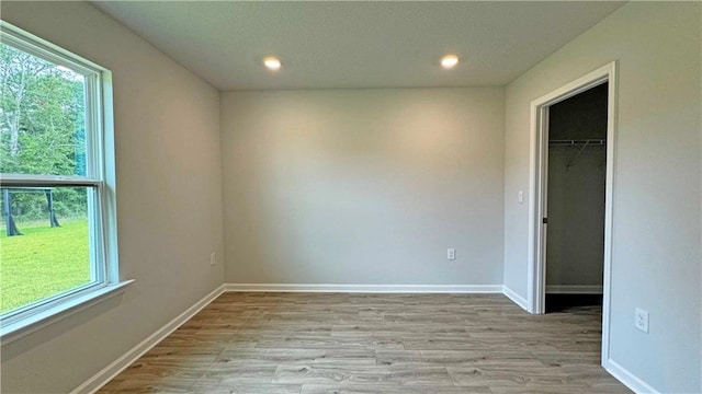 unfurnished room with light wood-type flooring