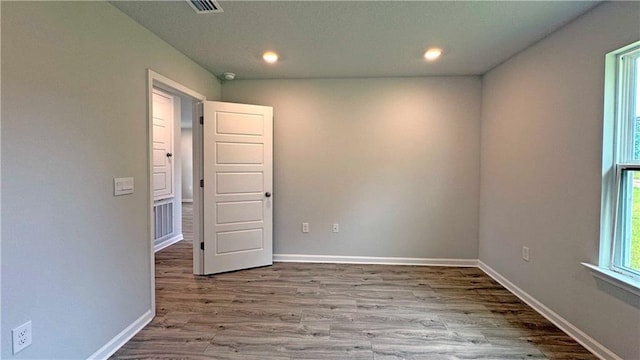 spare room with hardwood / wood-style floors