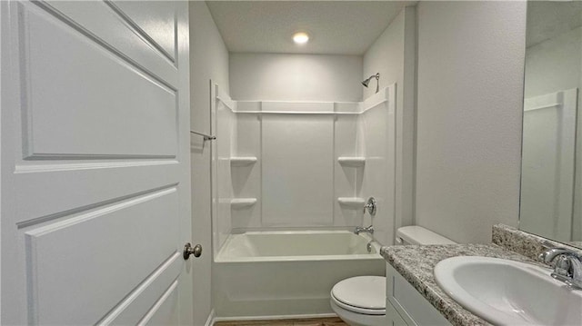 full bathroom featuring shower / washtub combination, vanity, a textured ceiling, and toilet