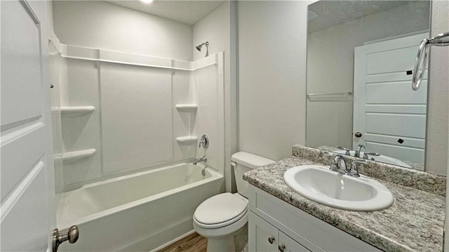 full bathroom with hardwood / wood-style floors, vanity, toilet, and bathing tub / shower combination